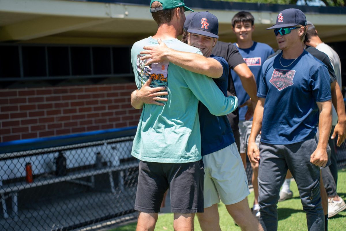 Keenan Morris hugs assistant coach Jared Noonan in the last moments of their final meeting of the season at Santa Rosas Cook Sypher Field on Tuesday, May 14, 2024.