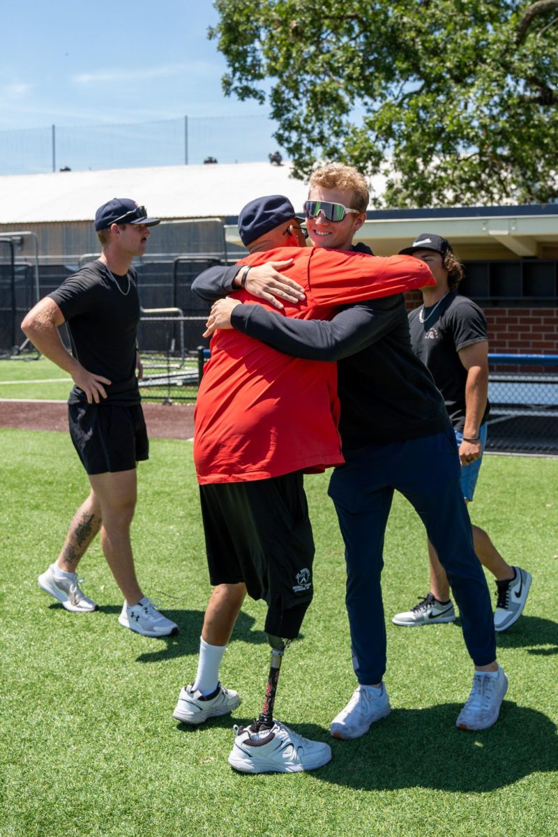 Aidan Lombardi goes in for the hug with assistant coach Tom Francois during the final meeting of the season at Santa Rosas Cook Sypher Field on Tuesday, May 14, 2024.