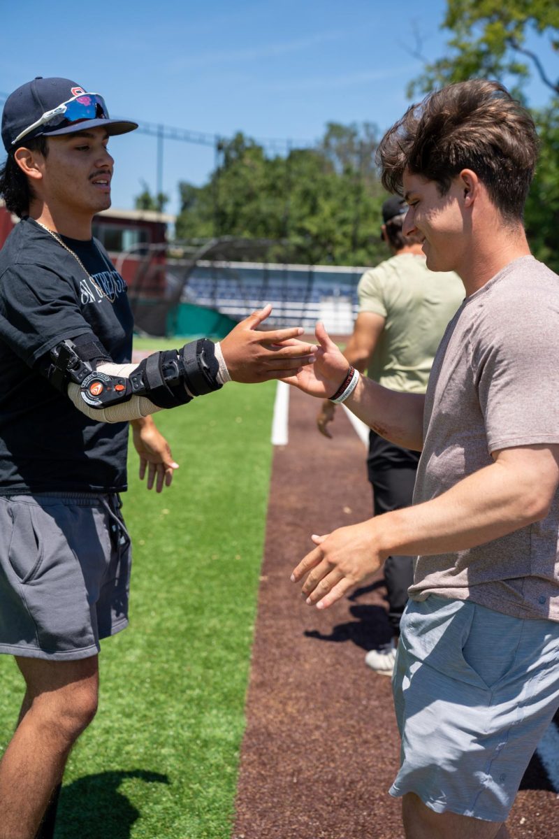 Tony Suarez, left, and Alex Leopard shake hands during the final meeting of the season at Santa Rosas Cook Sypher Field on Tuesday, May 14, 2024.