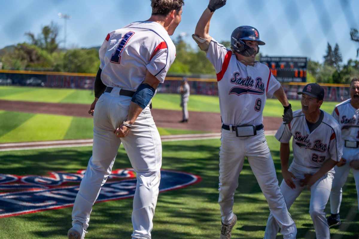 Center fielder Alex Leopard and pitcher Eli Yamanaka celebrate third baseman Keenan Morris, center, after a grand slam in the bottom of the fourth against College of San Mateo in game 1 of the CCCAA Regional Playoffs at home on Thursday, May 2, 2024.