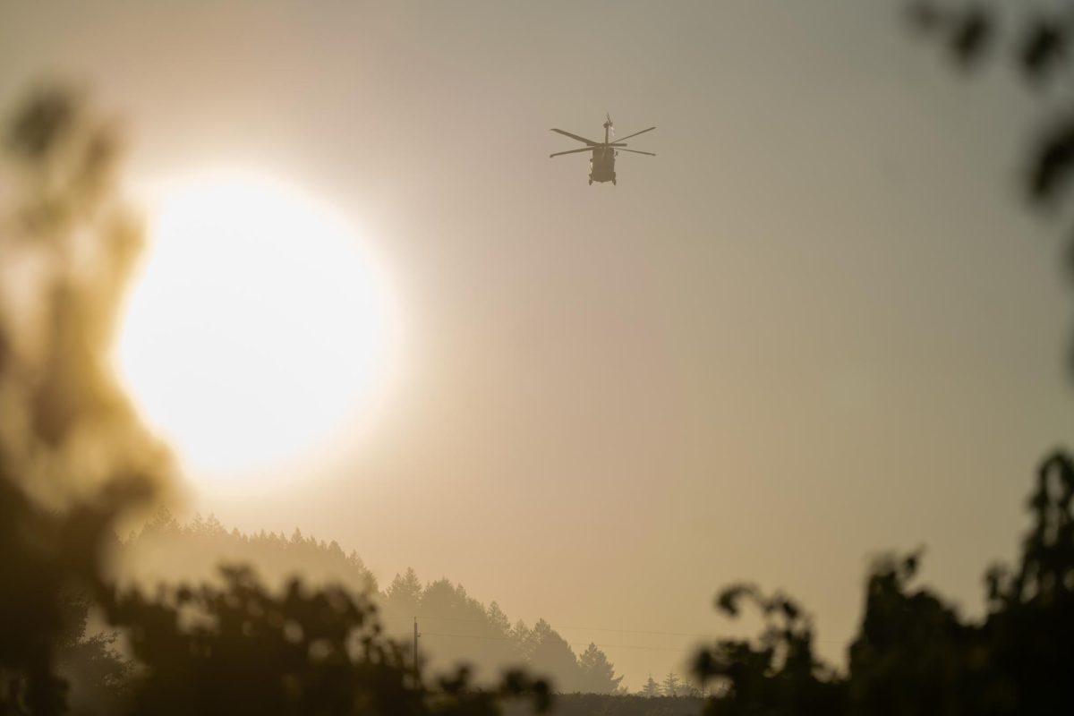 A helitanker flies over the Point Fire in Dry Creek Valley on Sunday, June 16, 2024.
