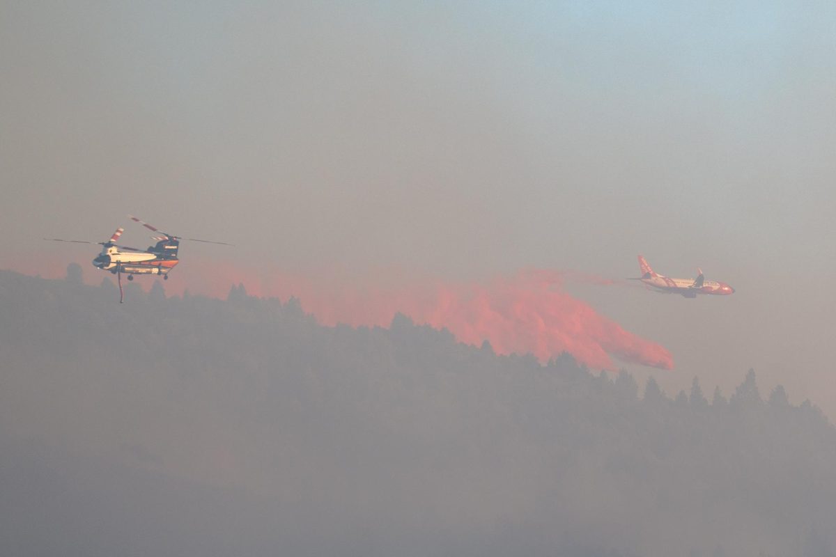 A helitanker and an airtanker work together to make a drop over the Point Fire in Dry Creek Valley on Sunday, June 16, 2024.