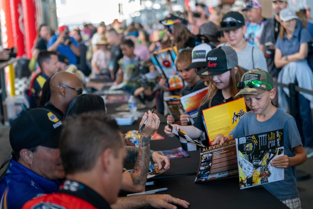 Kids line up for autographs from NHRA drivers, from Funny Car driver Ron Capps to Top Fuel driver Antron Brown and more at the DENSO NHRA Sonoma Nationals on Friday, July 26, 2024 in Sonoma.