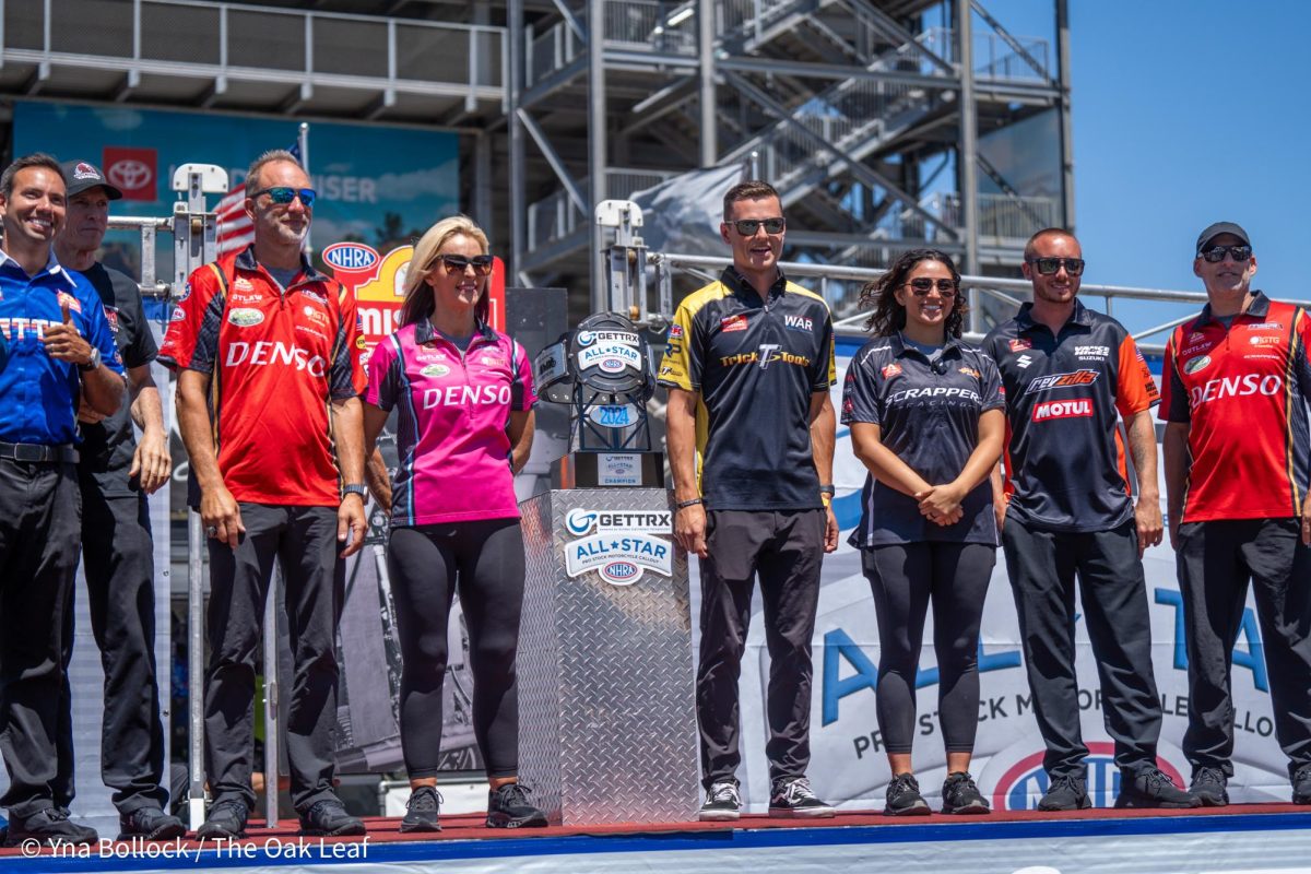 From left to right: Hector Arana Jr., Steve Johnson, Matt Smith, Angie Smith, Chase Van Sant, Jianna Evaristo, Gaige Herrera, and John Hall pose for a photo on the GETTRX NHRA All-Star Pro Stock Motorcycle Callout stage at Sonoma Raceway on Friday, July 26, 2024 in Sonoma.