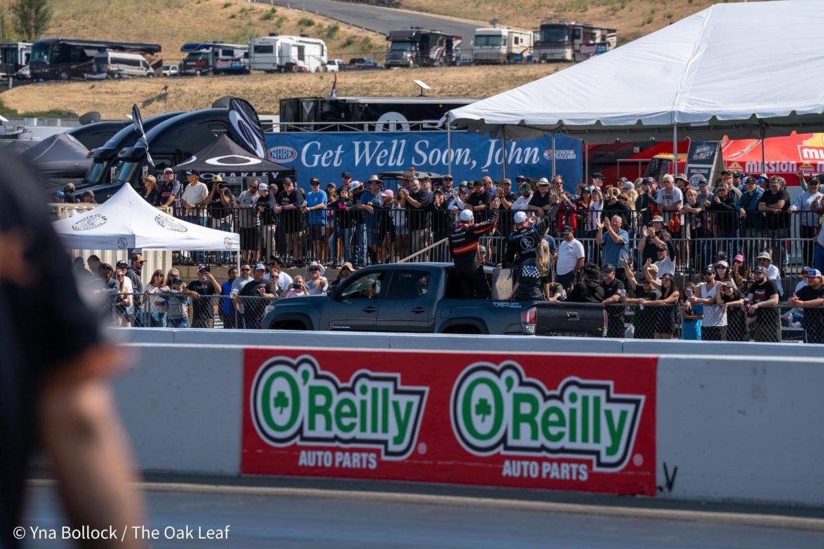 Another victory lap through Thunder Alley and the grandstands as Funny Car drivers Bob Tasca III (standing left) and Austin Prock (standing right) make their way back towards the starting line at the DENSO NHRA Sonoma Nationals on Saturday, July 27, 2024 in Sonoma. 