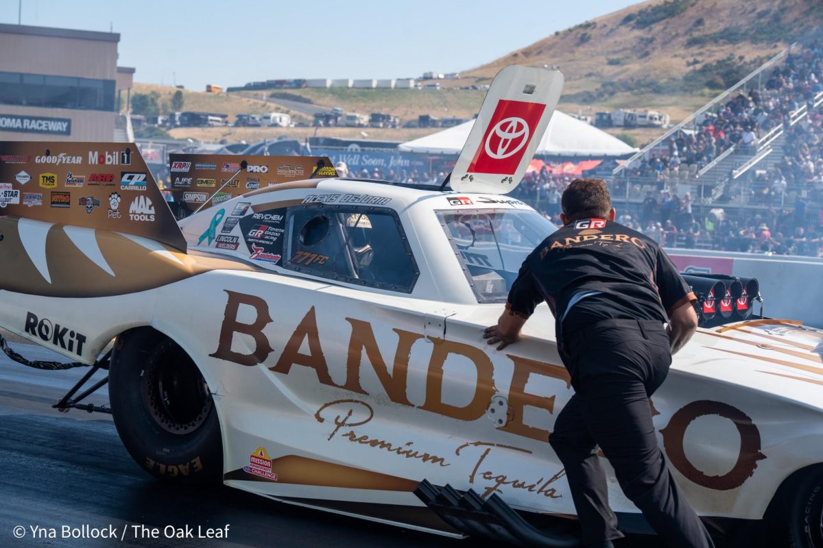 A member of the Bandero pit crew pushes Alexis DeJoria back to the starting line prior to beginning her run at the DENSO NHRA Sonoma Nationals on Saturday, July 27, 2024 in Sonoma. 