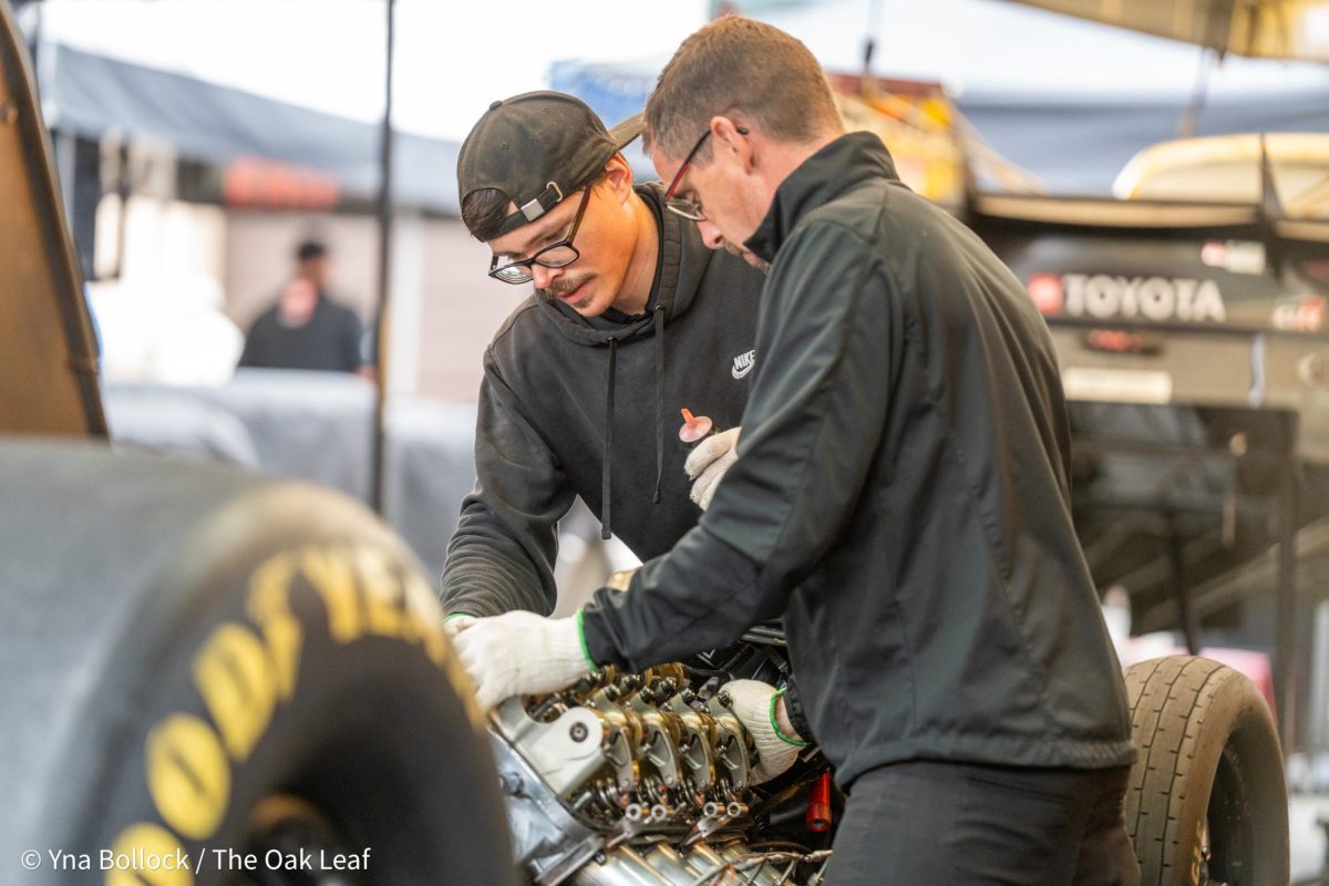 Crew members make adjustments to a vehicle in the pit ahead of Saturday's first round at the DENSO NHRA Sonoma Nationals on Saturday, July 27, 2024 in Sonoma. 