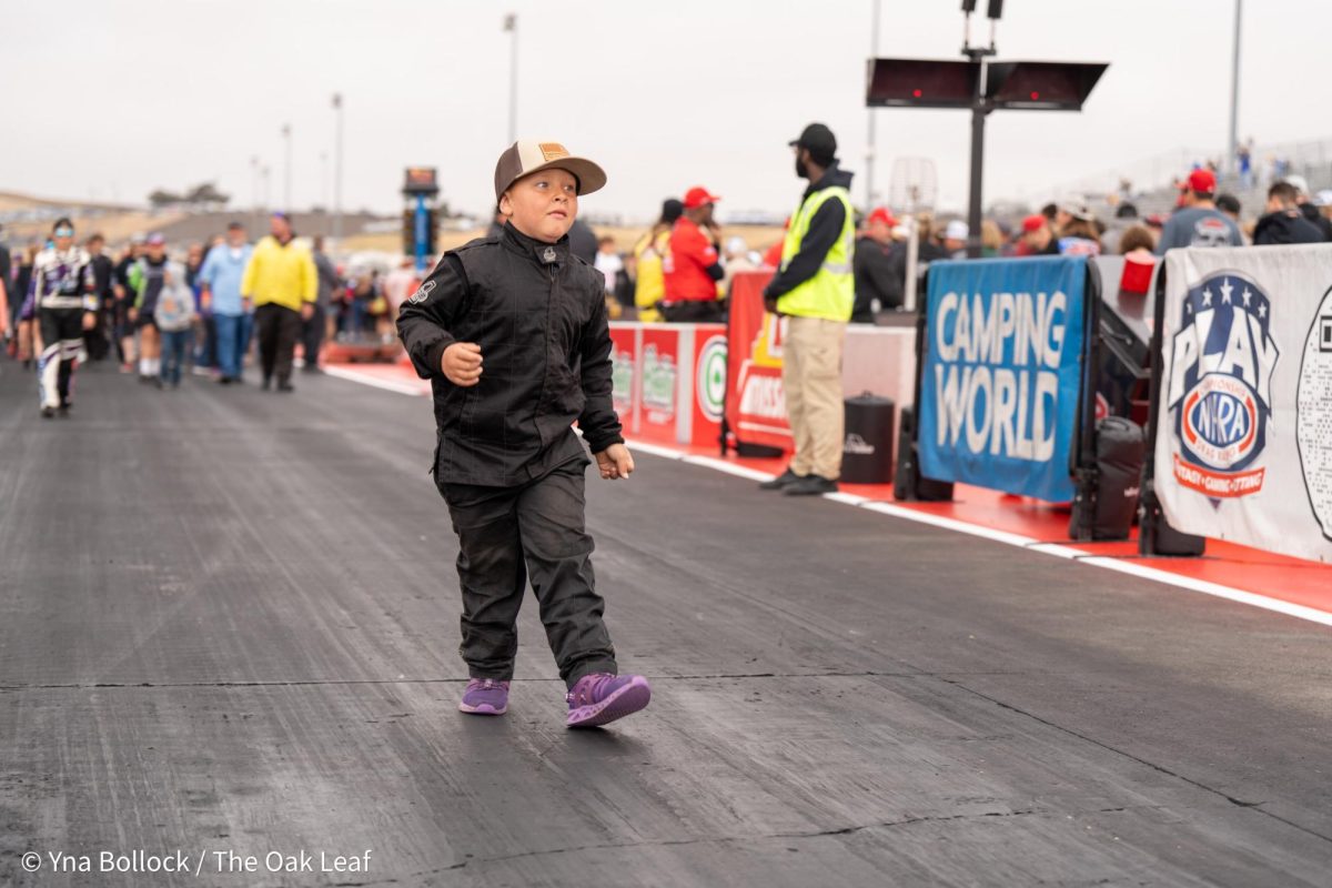 A young fan struts back to the starting line after the Seal Master NHRA Track Walk at the DENSO NHRA Sonoma Nationals on Sunday, July 28, 2024 in Sonoma. 