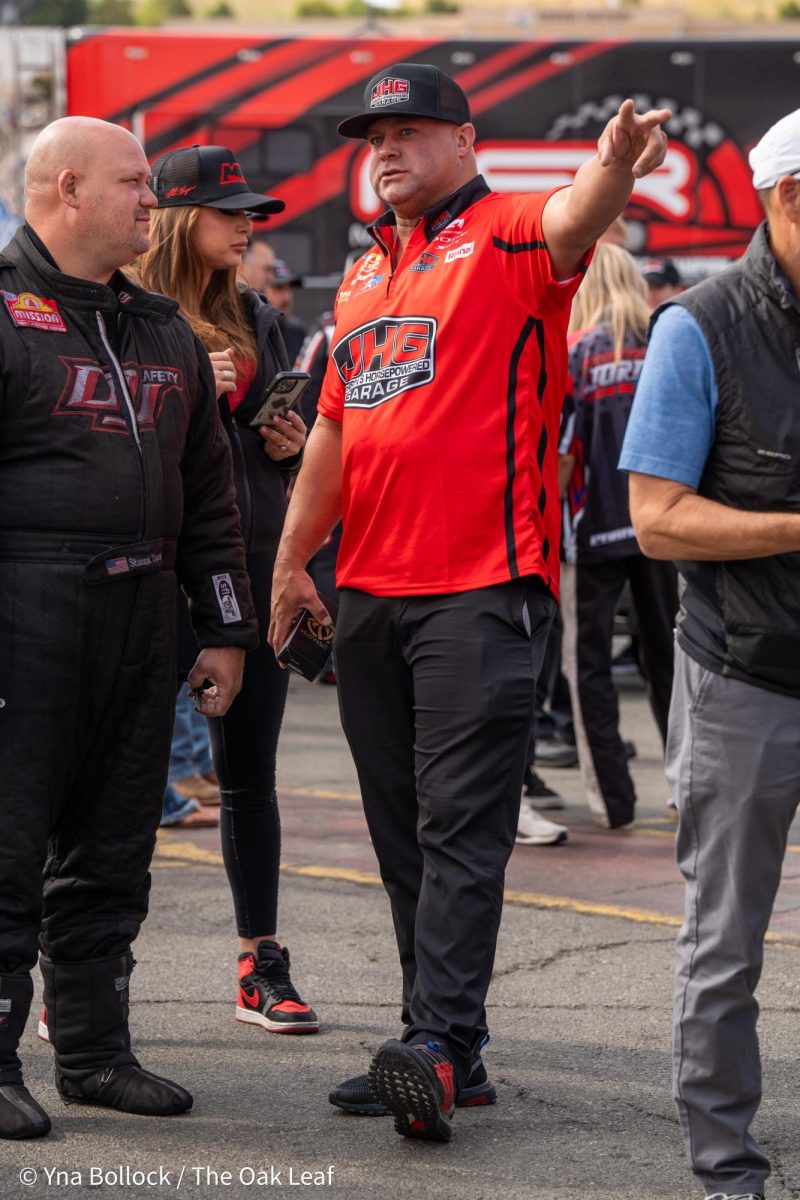 Funny Car drivers (left to right) Steven Densham and Matt Hagan chat while waiting to enter the stage for driver introductions during the pre-race ceremonies at the DENSO NHRA Sonoma Nationals on Sunday, July 28, 2024 in Sonoma. 