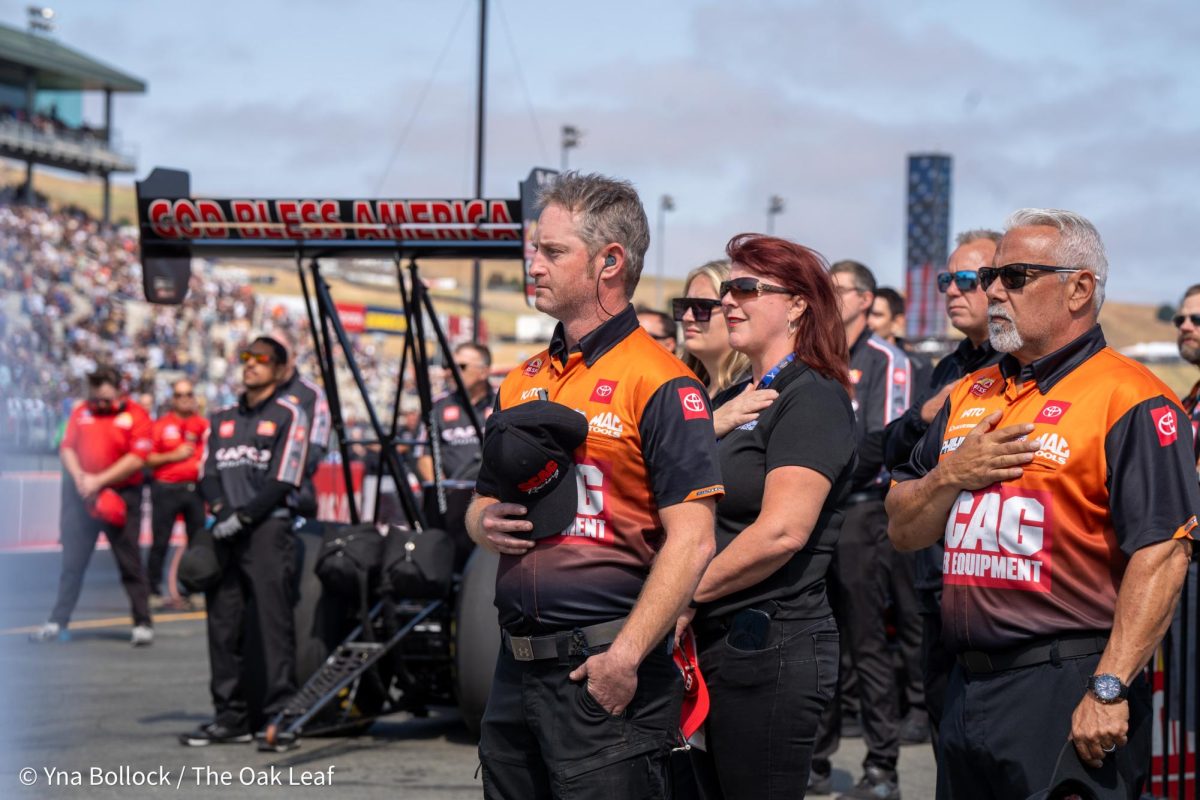 Members of the SCAG Power Equipment racing team stand solemnly for the national anthem at the DENSO NHRA Sonoma Nationals on Sunday, July 28, 2024 in Sonoma. 