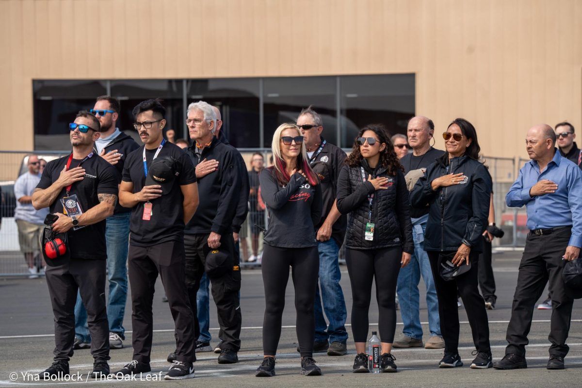 Pro Stock Motorcycle drivers (center left to right) Angie Smith and Jianna Evaristo, along with Top Fuel driver Mike Salinas (far right) stand solemnly for the national anthem at the DENSO NHRA Sonoma Nationals on Sunday, July 28, 2024 in Sonoma. 