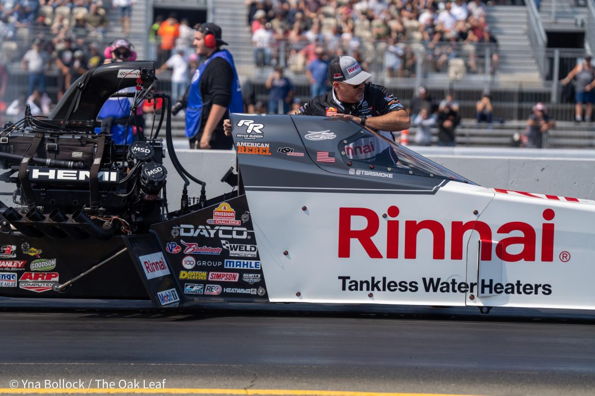 Top Fuel driver Tony "Smoke" Stewart is pushed back to the starting line by a member of his crew at the DENSO NHRA Sonoma Nationals on Sunday, July 28, 2024 in Sonoma. 