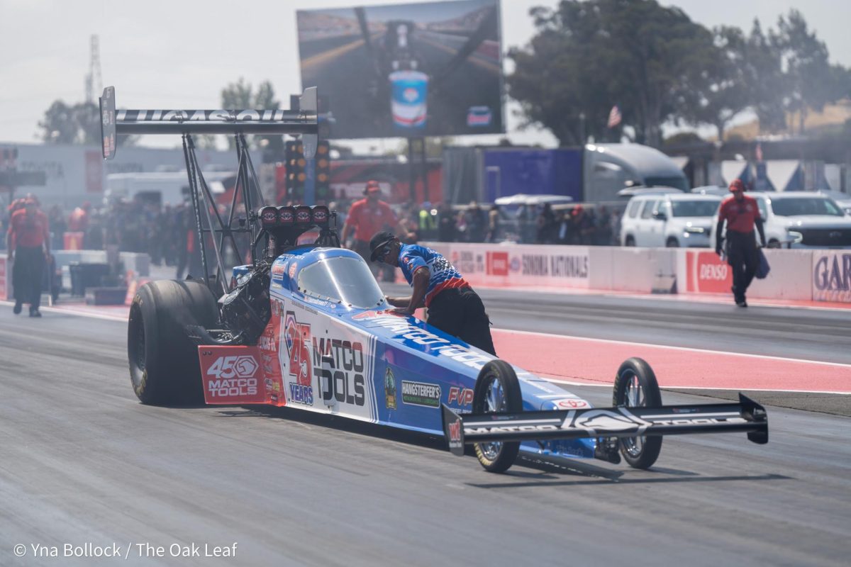 Top Fuel driver Antron Brown is pushed back to the starting line by a member of his crew at the DENSO NHRA Sonoma Nationals on Sunday, July 28, 2024 in Sonoma. 