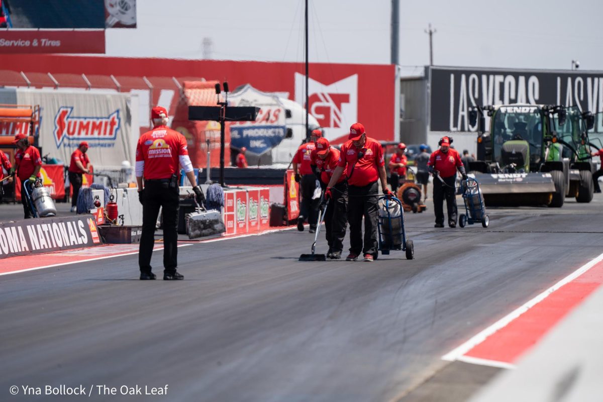 Various members of the pit crew maintain the track ahead of the next Top Fuel qualifying round at the DENSO NHRA Sonoma Nationals on Sunday, July 28, 2024 in Sonoma.