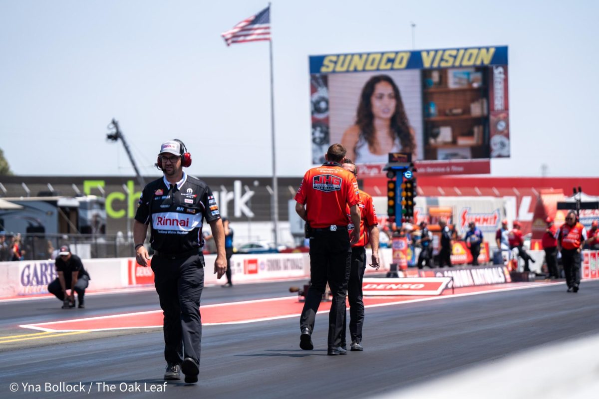 Crew members assess the track ahead of the final qualifying round for Top Fuel at the DENSO NHRA Sonoma Nationals on Sunday, July 28, 2024 in Sonoma.