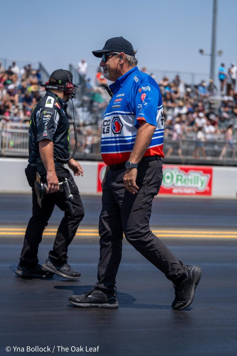 Crew members walk and assess the track for the final round of Top Fuel qualifiers at the DENSO NHRA Sonoma Nationals on Sunday, July 28, 2024 in Sonoma.