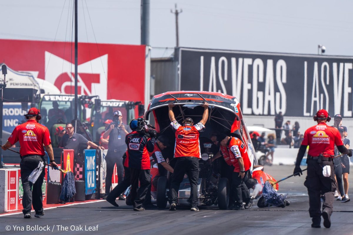 Donning a helmet emblazoned with "BT3", Funny Car driver Bob Tasca III is secured into his vehicle prior to racing against Austin Prock in the semi-finals at the DENSO NHRA Sonoma Nationals on Sunday, July 28, 2024 in Sonoma. 