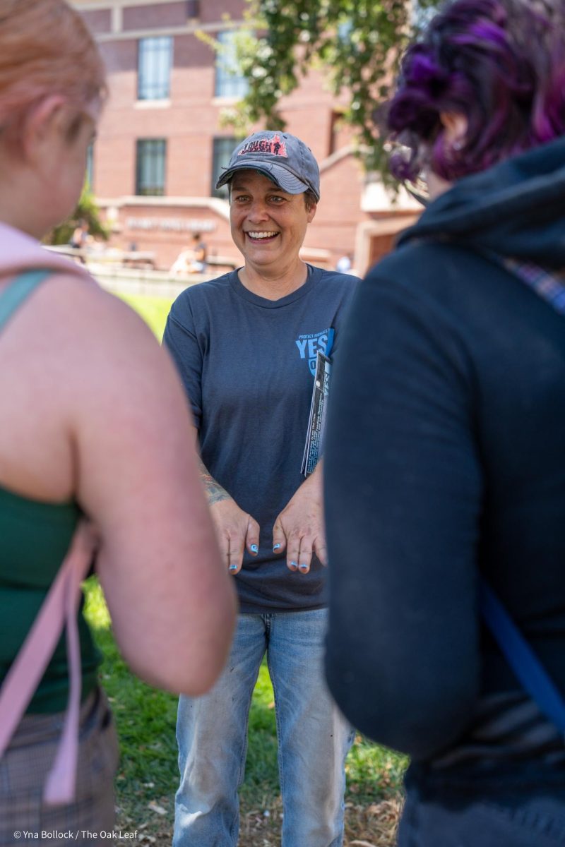 Organizer Carla Cabral shows off a fresh set of nails adorned with "Yes on J" to SRJC students in the quad on Thursday, August 22, 2024 in Santa Rosa.