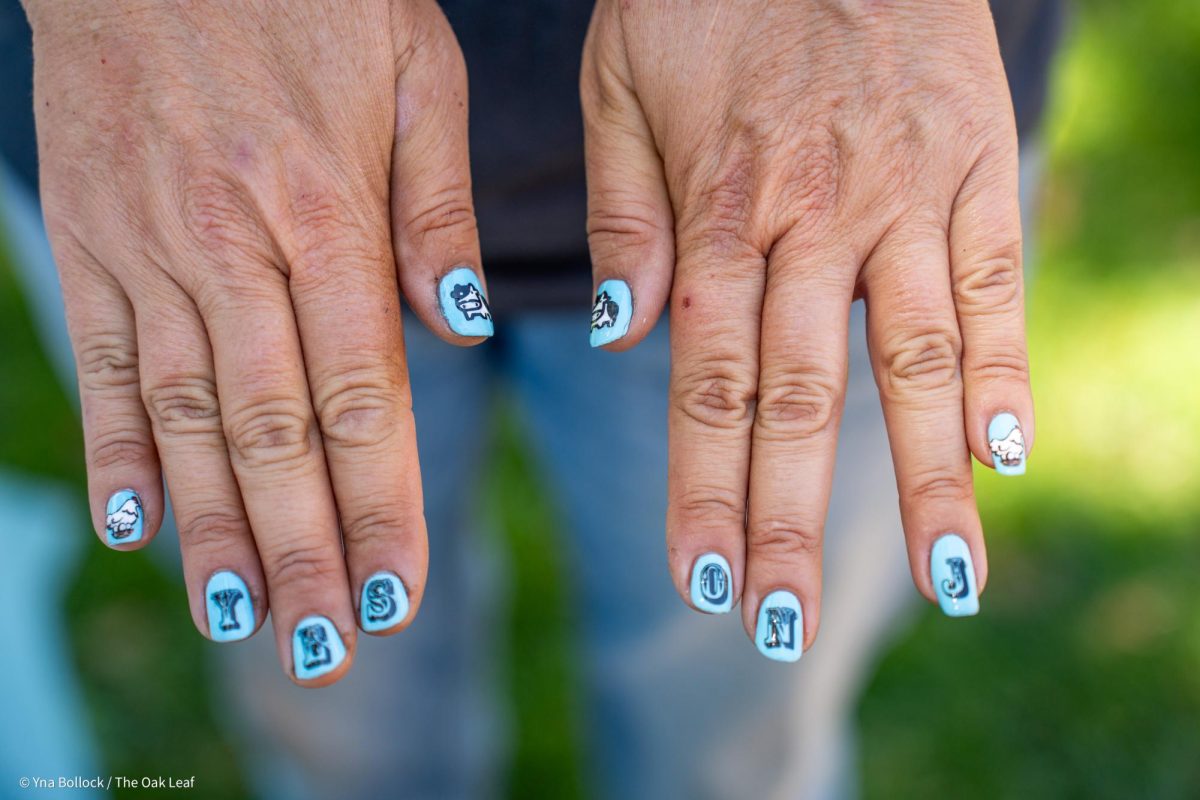 Organizer Carla Cabral shows off a fresh set of nails adorned with "Yes on J" to SRJC students in the quad on Thursday, August 22, 2024 in Santa Rosa.