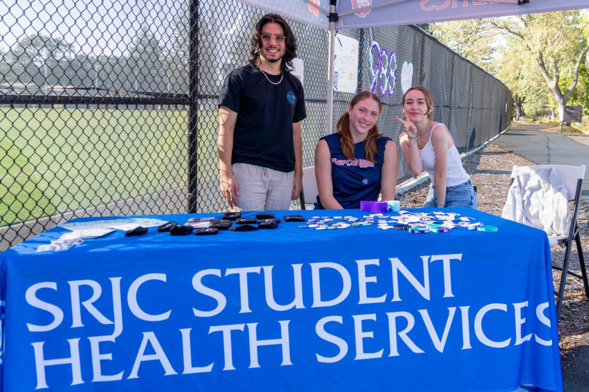 (from left to right) J Barnes, Katy Brenninger (volleyball), and Jasmine Ruel help hand out collateral available to students for suicide awareness at the women's soccer game against Hartnell on Sept. 24, 2024 