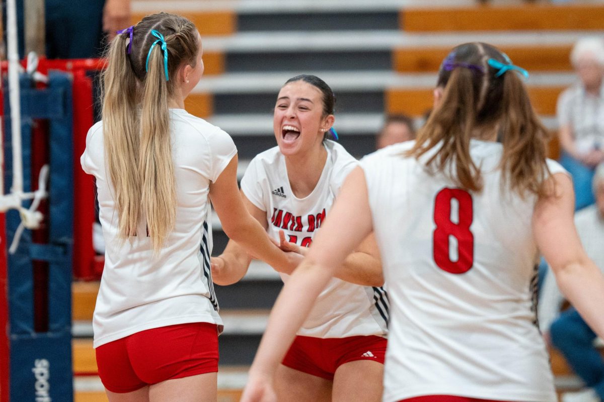 (left to right) Kiana Walker, Lily Comma, and Katie Brenninger celebrate together after a hard fought point against Cosumnes River on Wednesday, Sept. 18, 2024