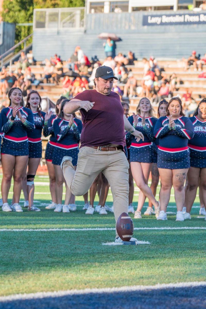 A member of the audience attempts the field goal challenge during halftime at Santa Rosa's Bailey Field on Saturday, September 7, 2024.