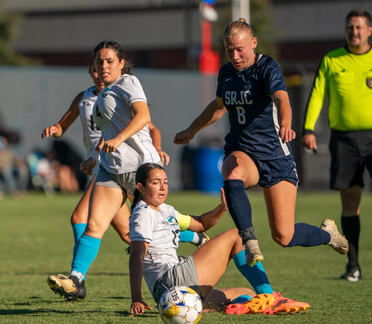 Forward Taylor Gandy leaps past Clovis' crumpled midfielder Madison Martinez at home against Clovis Community College on Thursday, September 6, 2024.