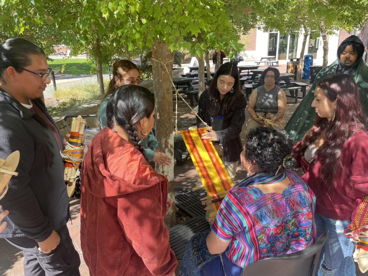 Oak Leaf reporter Jordan Garcia pushing down on Sari’s loom to feel the tension of the threads and its sturdiness at Santa Rosa Junior College 20 Sept. 2024