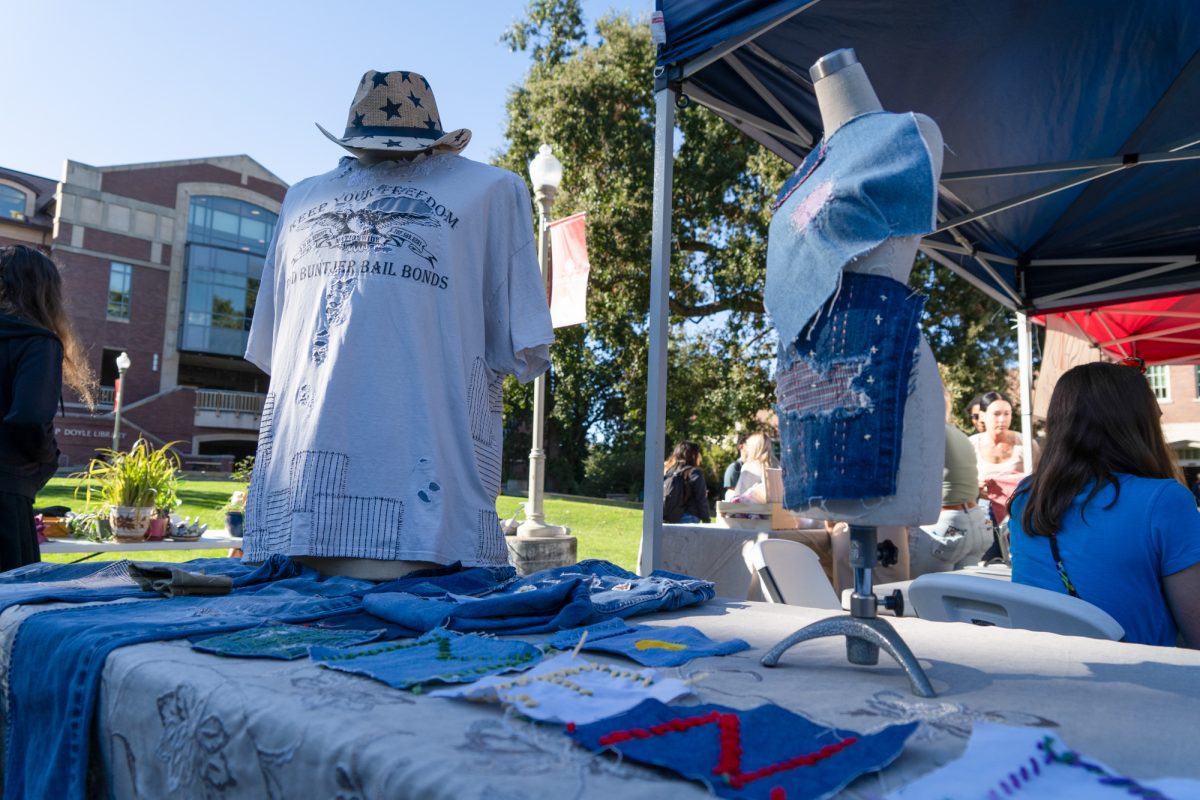 Mended garments and fabrics are displayed by the Fashion Studies booth at the Green Living Fair in the Bertolini Quad on the Santa Rosa campus on Thursday, Oct. 10, 2024.