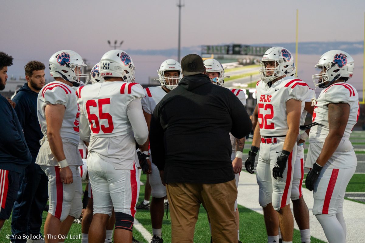 Defense line coach Martin Tevaseu speaks to the players during the game against Laney College on Friday, Oct. 4, 2024.