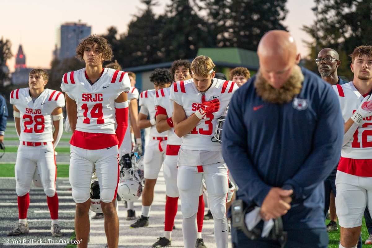 Bear Cubs stand somberly for the national anthem ahead of the game against Laney College on Friday, Oct. 4, 2024.