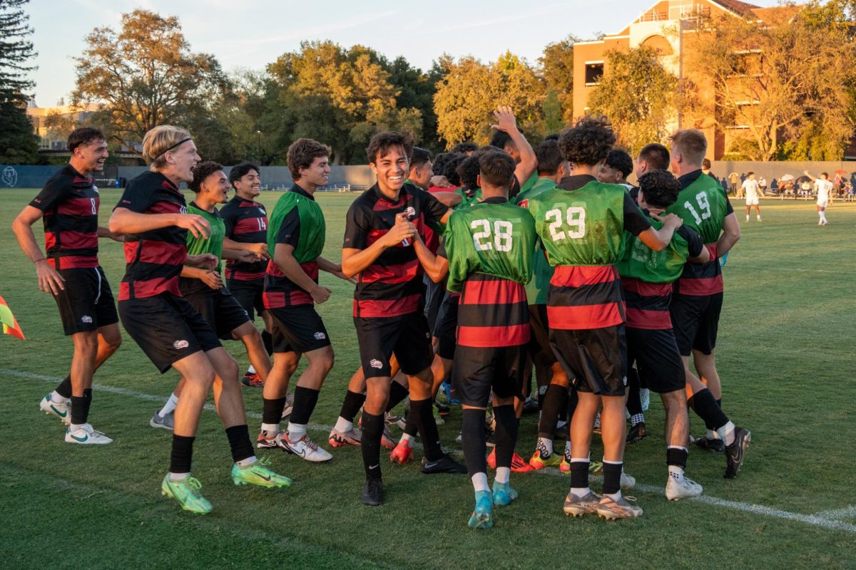 The team surrounds defender Joseangel Carrillo-Contreras is euphoric after he scores the equalizer against Folsom Lake Friday, Oct. 18, 2024.