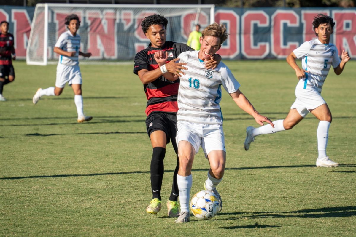 Bear Cubs defender Raffino Landford battles with Folsom Lake’s midfielder Issac Harrison on Friday, Oct. 18 2024. 