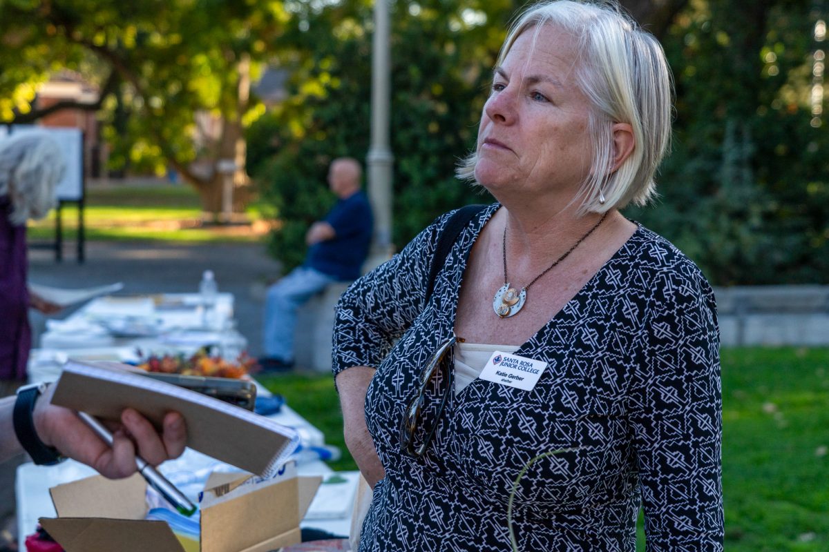 Katie Berger, chair of the Environmental Science and Geography department, manages her booth at the Green Living Fair in the Bertolini Quad on the Santa Rosa campus on Thursday, Oct. 10, 2024.