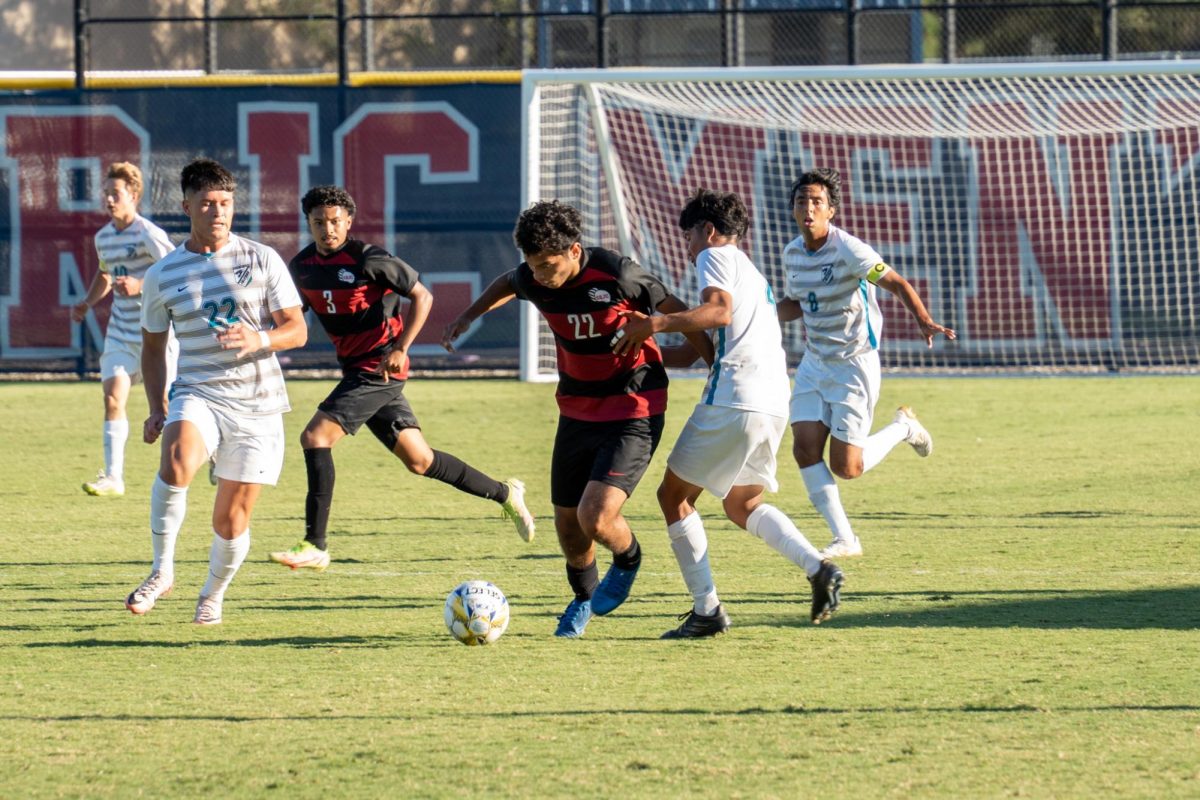 Santa Rosa’s midfielder Edgar Nunez shrugs off his marker against Folsom Lake on Friday, Oct. 18, 2024.