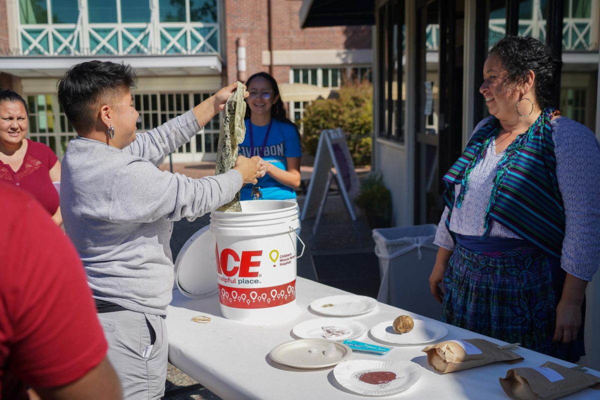 Event attendees take turns picking out bandanas to dye at Santa Rosa Junior College on Sept. 19, 2024.