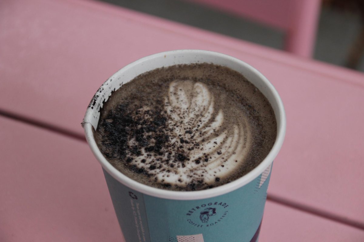 Retrograde's Black Cat Mocha in a to-go cup, topped with a sprinkle of black cocoa. Oak Leaf Reporter Cristan Molinelli-Ruberto enjoyed the overcast early morning at the outdoor patio in Sebastopol on Friday, Oct. 11. 