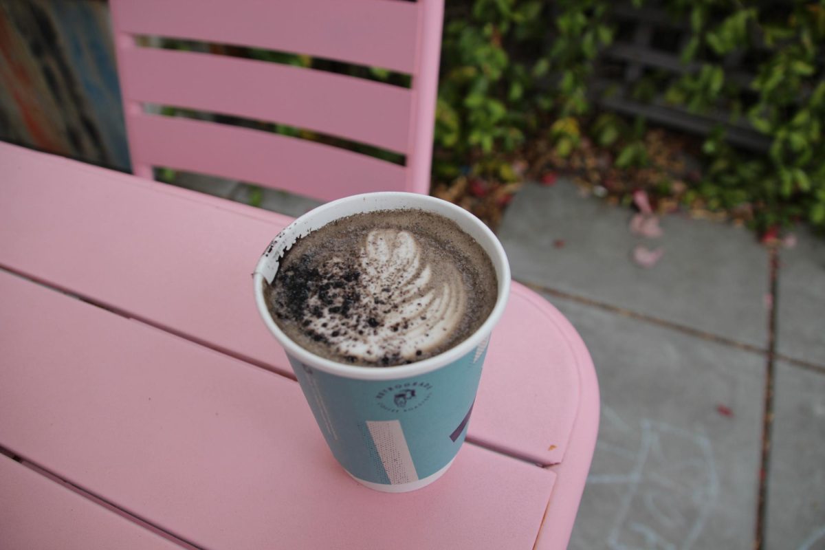 Retrograde's Black Cat Mocha in a to-go cup, topped with a sprinkle of black cocoa. Oak Leaf Reporter Cristan Molinelli-Ruberto enjoyed the overcast early morning at the outdoor patio in Sebastopol on Friday, Oct. 11. 