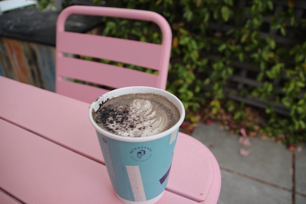 Retrograde's Black Cat Mocha in a to-go cup, topped with a sprinkle of black cocoa. Oak Leaf Reporter Cristan Molinelli-Ruberto enjoyed the overcast early morning at the outdoor patio in Sebastopol on Friday, Oct. 11. 