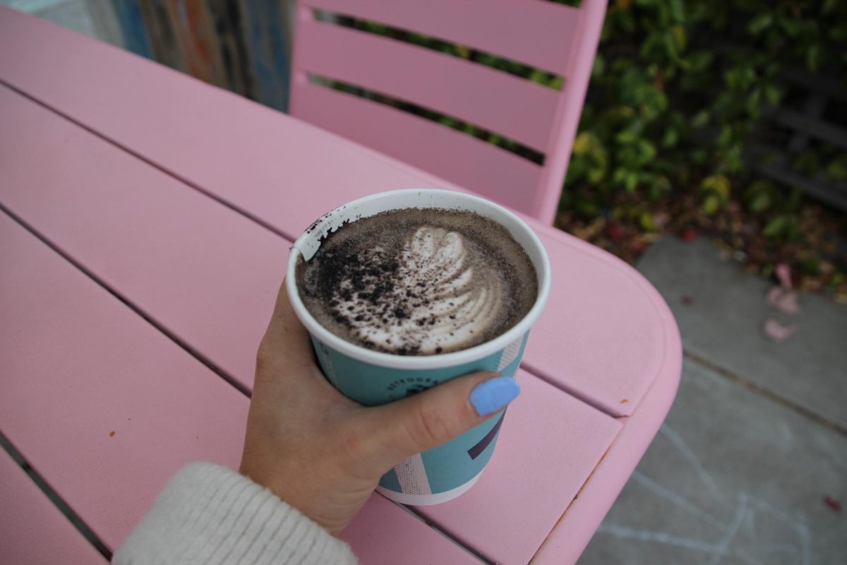 Retrograde's Black Cat Mocha in a to-go cup, topped with a sprinkle of black cocoa. Oak Leaf Reporter Cristan Molinelli-Ruberto enjoyed the overcast early morning at the outdoor patio in Sebastopol on Friday, Oct. 11. 