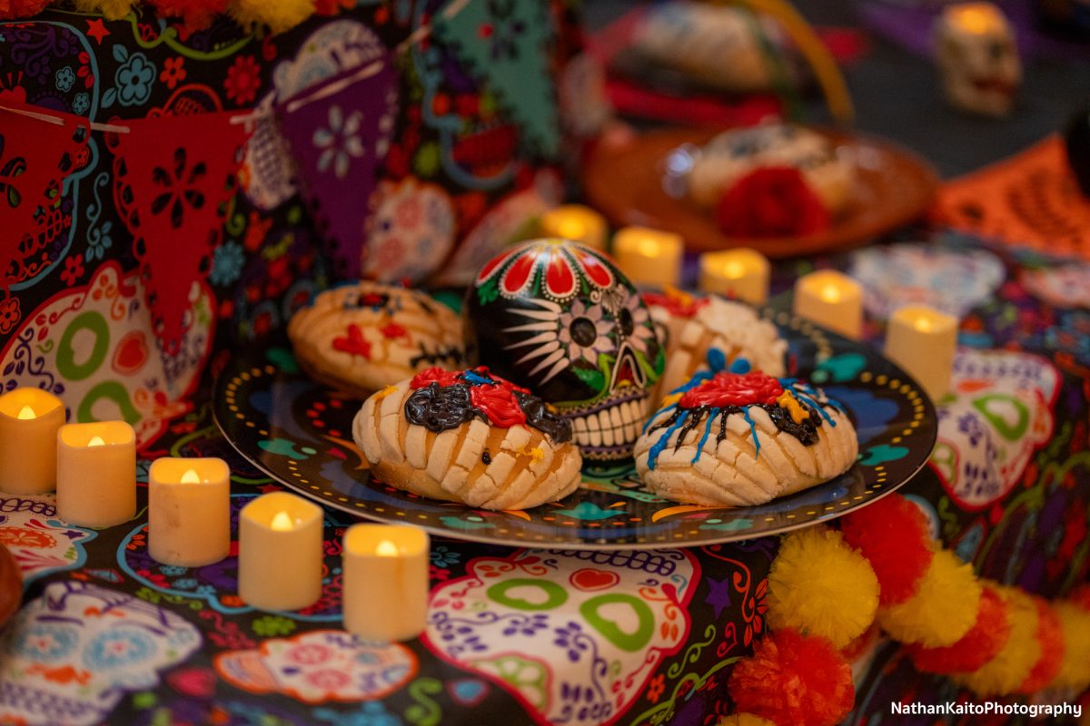 A plate of decorated conchas are placed on an altar as an ofrenda (offering) during the Dia De Los Muertos event at the Bertolini Student Center on Wednesday, Oct. 23, 2024.