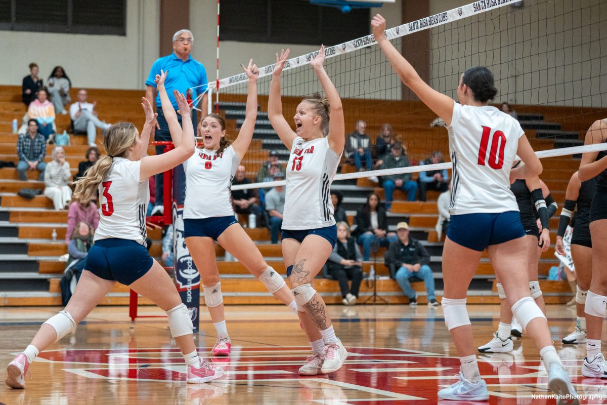 Santa Rosa’s Sierra Yates-Bruch, left, Katie Brenninger, center left, Sarah Thornton, center right, and Lily Comma, right, celebrates a point after a hard rally against San Joaquin Delta at Haehl Pavilion on Friday, Nov. 15, 2024.