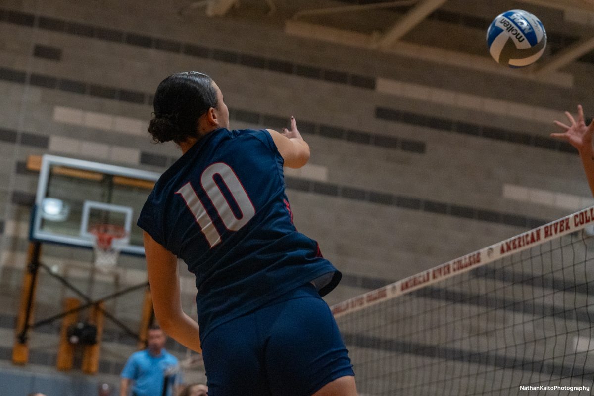 Bear Cubs’ setter/opposite Lily Comma jumps high for a spike against American River at the American River gym on Tuesday, Nov. 26. 