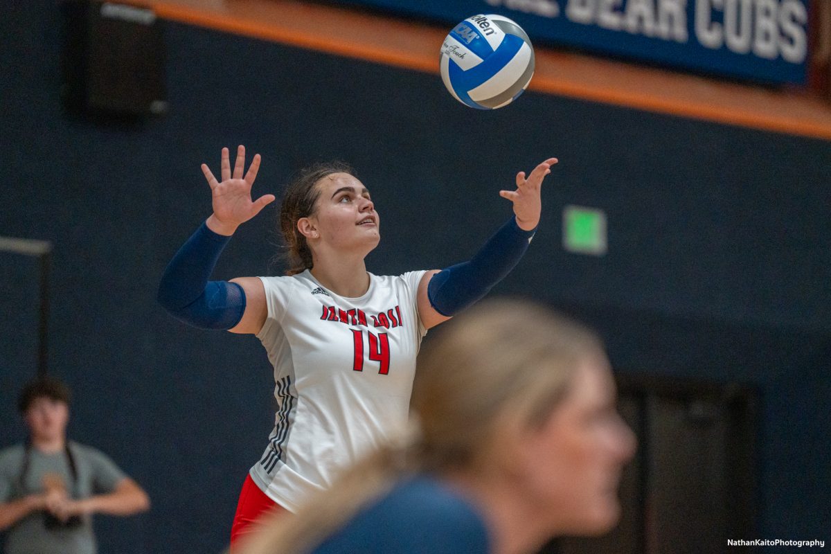 Santa Rosa’s setter Natalie Walsh serves the ball back into action as head coach Ally Sather watches on against Sacramento City College at Haehl Pavilion on Friday, Nov. 1, 2024. 