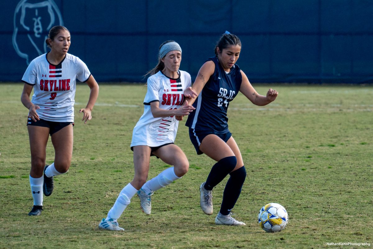 Bear Cubs’ midfielder Ashley Vigil holds off her marker during the opening stages of the first half against Skyline College at home on Nov. 23, 2024