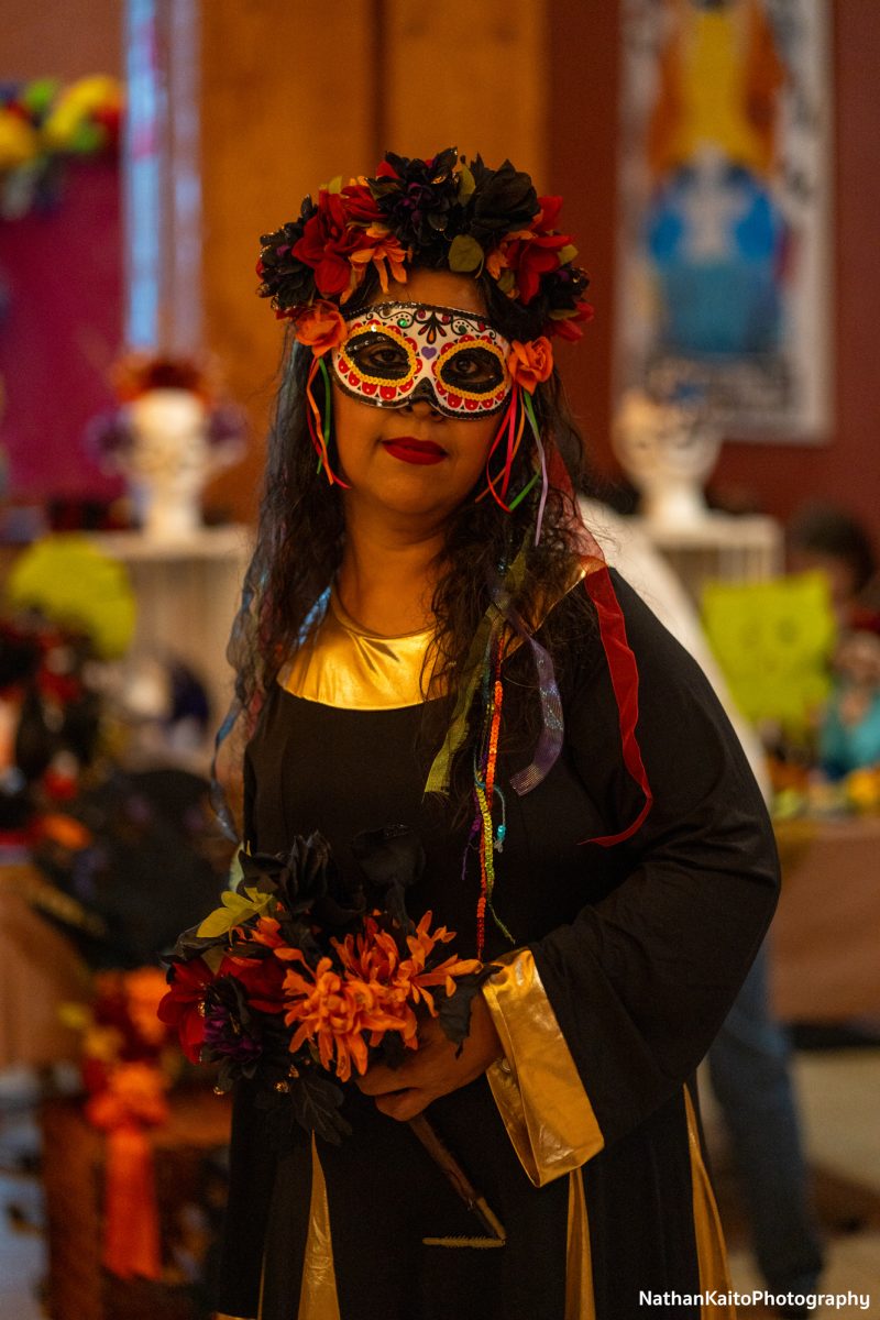 Juanita Estrada, adorned in traditional Dia De Los Muertos attire, poses during the Dia De Los Muertos event at the Bertolini Student Center  on Wednesday, Oct. 23.