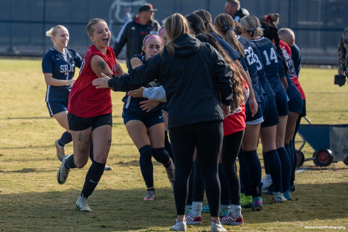 Bear Cubs’ Dorothy Nickel runs and high-fives the bench before their playoff match against Skyline College at home on Nov. 23, 2024