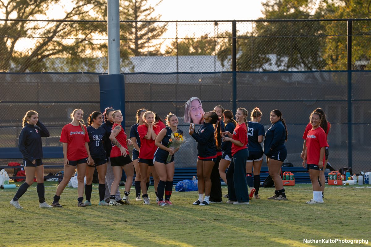 The Bear Cubs pose around a cut out of forward Genevieve Stewart after their draw against Cosumnes River on Tuesday, Oct. 29, 2024.