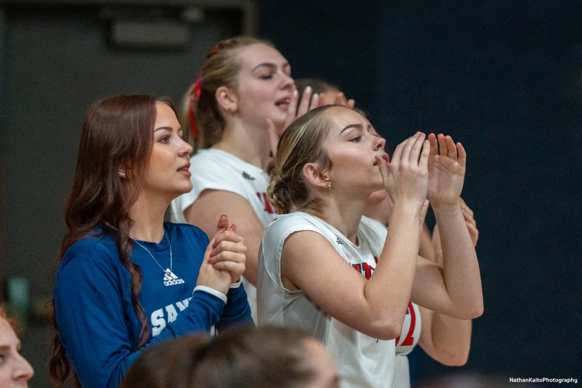 Santa Rosa’s red shirt Jillian Mefferd and defensive specialist Jasmine Forster chants to rally the team against San Joaquin Delta at Haehl Pavilion on Friday, Nov. 15, 2024.