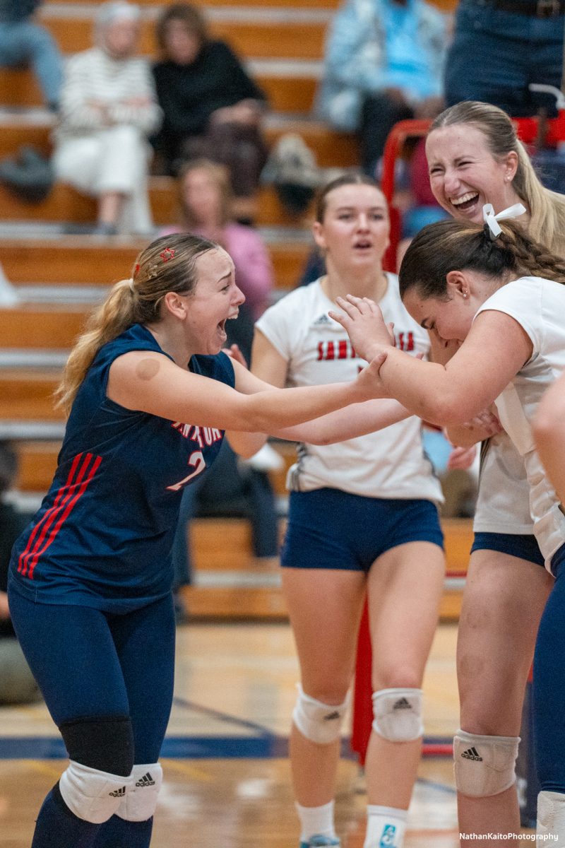 Santa Rosa’s Jaiden Brooner and Kiana Walker embraces setter, Natalie Walsh in the latter stages of the third set against San Joaquin Delta at Haehl Pavilion on Friday, Nov. 15, 2024.